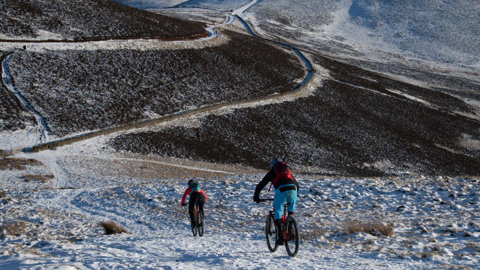  Mountain bikers riding in snow. 