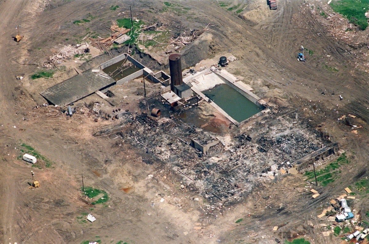 This aerial shot taken 21 April 1993 in Waco shows the burnt remains of the compound (J DAVID AKE/AFP via Getty Images)
