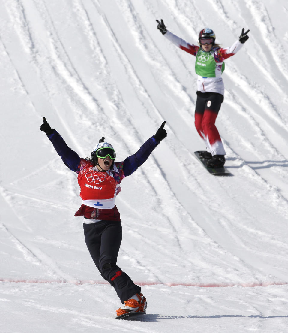 Czech Republic's Eva Samkova celebrates after taking the gold medal in the women's snowboard cross final, ahead of silver medalist Dominique Maltais of Canada, right, at the Rosa Khutor Extreme Park, at the 2014 Winter Olympics, Sunday, Feb. 16, 2014, in Krasnaya Polyana, Russia. (AP Photo/Andy Wong)