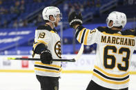 Boston Bruins forward Matt Grzelcyk (48) celebrates his goal with forward Brad Marchand (63) during the second period of the team's NHL hockey game against the Buffalo Sabres, Thursday, April 22, 2021, in Buffalo, N.Y. (AP Photo/Jeffrey T. Barnes)