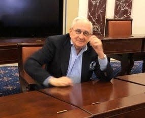 Jay Berman sits at Birch Bayh's senate desk.