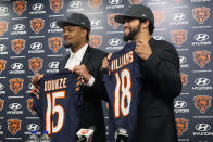 Chicago Bears draft picks wide receiver Rome Odunze, left, and quarterback Caleb Williams hold up jerseys during a news conference held by the NFL football team in Lake Forest, Ill., Friday, April 26, 2024. (AP Photo/Nam Y. Huh)