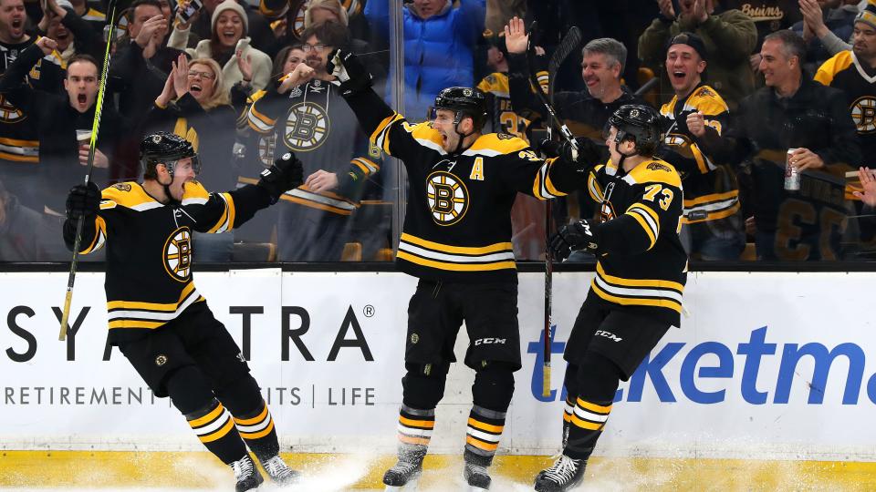 <p>BOSTON, MASSACHUSETTS - MARCH 07: Patrice Bergeron celebrates with John Moore #27 and Charlie McAvoy #73 after scoring a goal against the Panthers during the third period at TD Garden on March 07, 2019.(Photo by Maddie Meyer/Getty Images)</p>