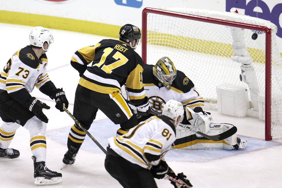 Pittsburgh Penguins' Bryan Rust (17) puts a shot over Boston Bruins goaltender Jeremy Swayman (1) for a goal during the first period of an NHL hockey game in Pittsburgh, Saturday, April 1, 2023. (AP Photo/Gene J. Puskar)