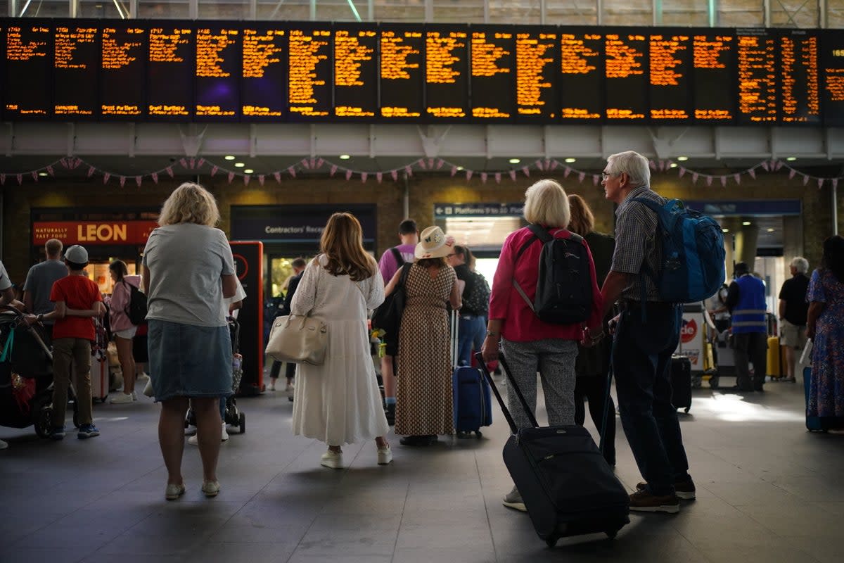 Passengers at London King’s Cross (Yui Mok/PA) (PA Wire)