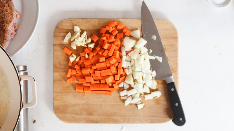 chopped carrots, onion, and garlic on cutting board
