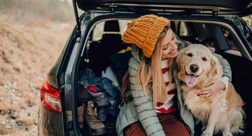 A woman and a dog in a car. Source: Getty Images