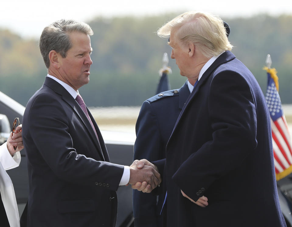 FILE - Georgia Gov. Brian Kemp, left, greets President Donald Trump as he arrives at Dobbins Air Reserve Base on Nov. 8, 2019, in Marietta, Ga. The Republican Kemp is working against Trump's 2024 candidacy and won't appear at a Georgia Republican Party convention in Columbus, Ga., on Saturday, June 10, 2023, where Trump is scheduled to appear. (Curtis Compton/Atlanta Journal-Constitution via AP)/Atlanta Journal-Constitution via AP, File)