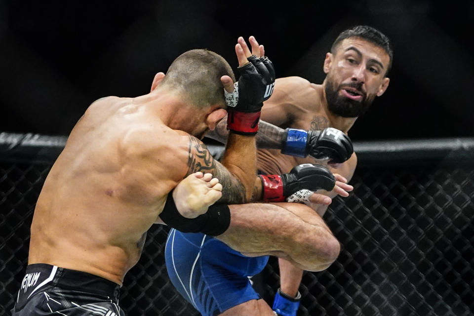 Chris Gutierrez, right, kicks Frankie Edgar during the first round of a bantamweight bout at the UFC 281 mixed martial arts event Saturday, Nov. 12, 2022, in New York. Gutierrez stopped Edgar in the first round. (AP Photo/Frank Franklin II)