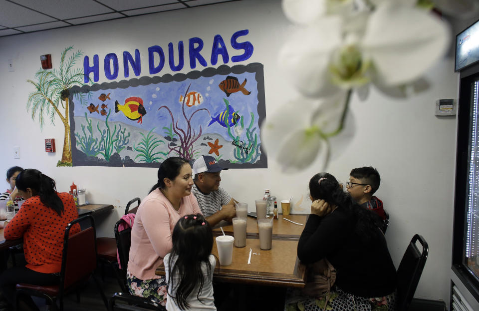 In this Thursday, June 27, 2019 photo diners eat in a Honduran-style restaurant in Chelsea, Mass. A recent study by the Pew Research Center shows the number of Central Americans in the United States increased over the last decade. Chelsea has exemplified that trend with a population that is more than 60 percent Latino. (AP Photo/Steven Senne)