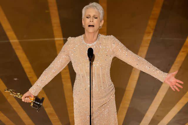 <p>Kevin Winter/Getty</p> Jamie Lee Curtis accepts the best supporting actress Academy Award in 2023.