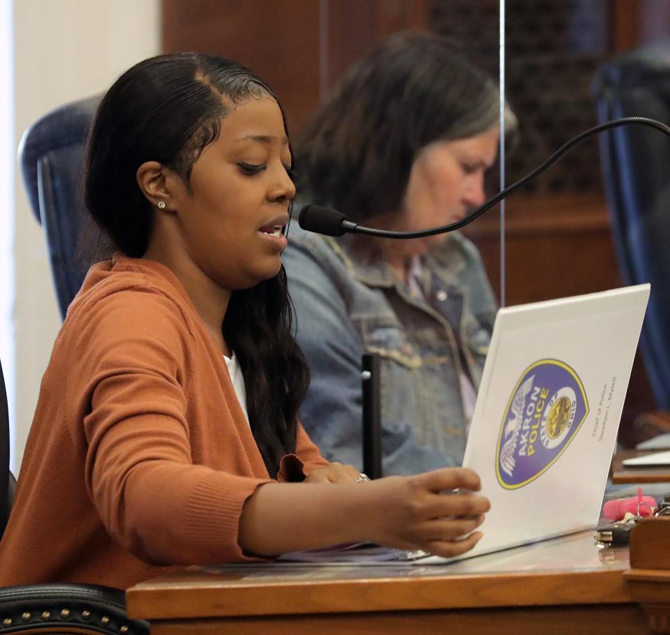 Tristan Reed looks over literature from the Akron Police Department during a recent police oversight board meeting.