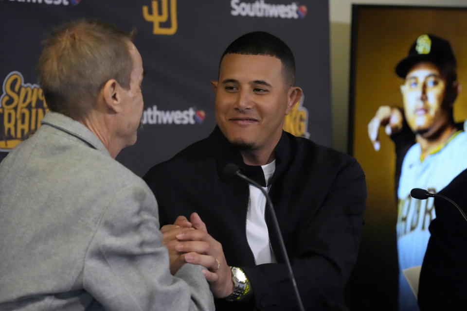 San Diego Padres third baseman Manny Machado shakes hands with owner Peter Seidler during a news conference to discuss his 11-year contract extension Tuesday, Feb. 28, 2023, at the team's spring training baseball facility in Peoria, Ariz. (AP Photo/Charlie Riedel)