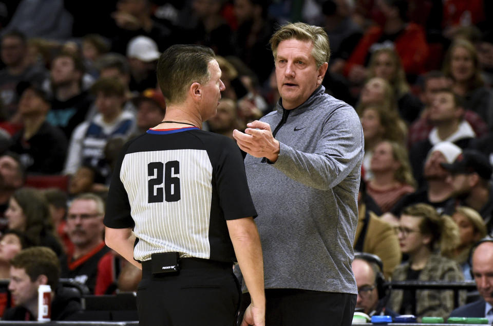 Minnesota Timberwolves coach Chris Finch, right, speaks with referee Pat Fraher during the first half of the team's NBA basketball game against the Portland Trail Blazers in Portland, Ore., Saturday, Dec. 10, 2022. (AP Photo/Steve Dykes)