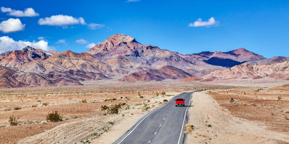 red truck driving towards mountains