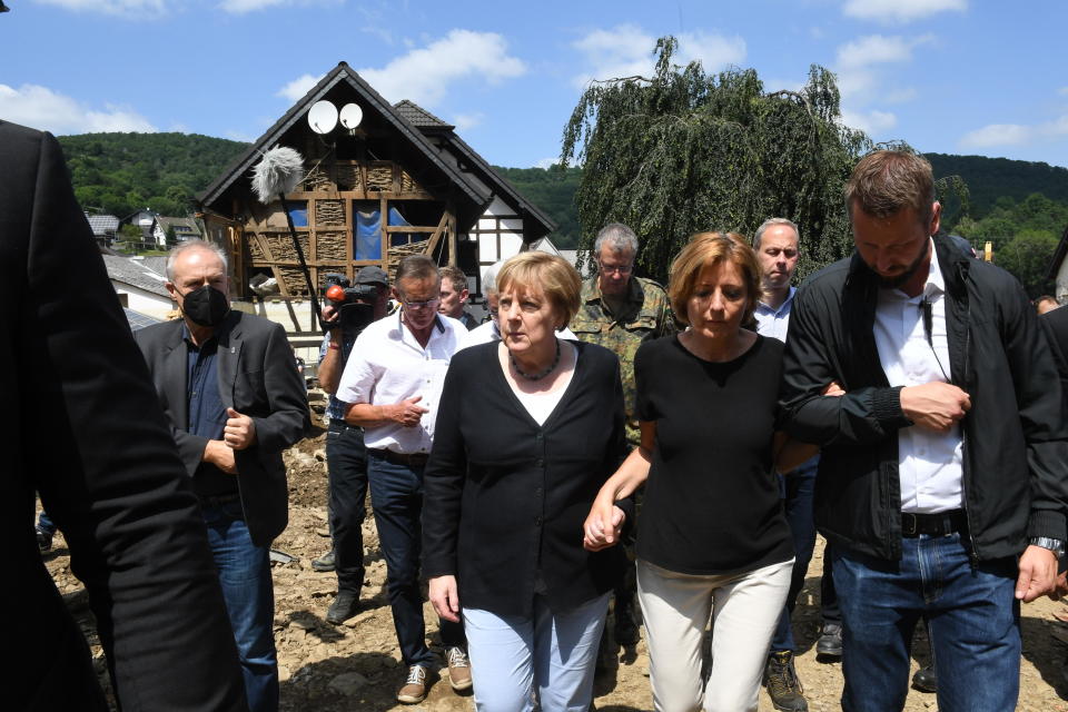 German Chancellor Angela Merkel (5thR) and Rhineland-Palatinate State Premier Malu Dreyer (3rdR) walk through the flood-ravaged village of Schuld on July 18, 2021 in Schuld, near Bad Neuenahr-Ahrweiler, Rhineland-Palatinate state, western Germany.  / Credit: Getty