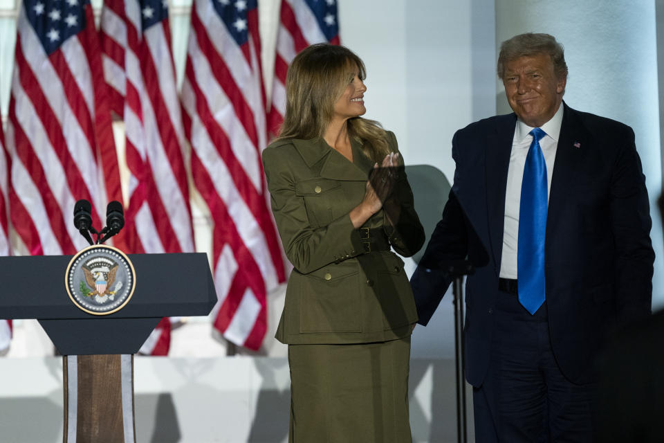 President Donald Trump joins first lady Melania Trump on stage after her speech to the 2020 Republican National Convention from the Rose Garden of the White House, Tuesday, Aug. 25, 2020, in Washington. (AP Photo/Evan Vucci)