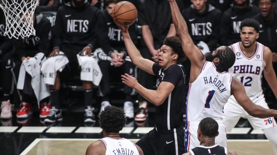 Apr 20, 2023; Brooklyn, New York, USA; Brooklyn Nets forward Cameron Johnson (2) drives past Philadelphia 76ers guard James Harden (1) for a layup during game three of the 2023 NBA playoffs at Barclays Center.