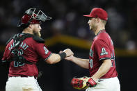 Arizona Diamondbacks relief pitcher Bryce Jarvis, right, celebrates with Diamondbacks catcher Tucker Barnhart after the final out in the ninth inning of a baseball game against the St. Louis Cardinals Sunday, April 14, 2024, in Phoenix. The Diamondbacks won 5-0. (AP Photo/Ross D. Franklin)