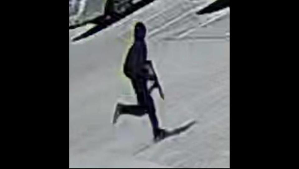 Dallas police say the man in this still from a surveillance video is suspected of walking into a Korean hair salon on May 11, shooting three women and fleeing to a maroon minivan.