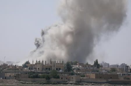  Smoke rises from the al-Mishlab district at Raqqa's southeastern outskirts (Reuters)