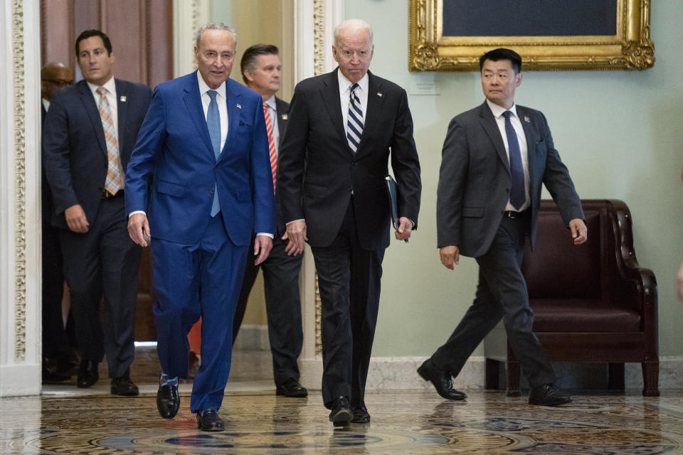 Senate Majority Leader Sen. Chuck Schumer of N.Y., walks with President Joe Biden as he arrives on Capitol Hill to meet with Senate Democrats, Wednesday, July 14, 2021, in Washington. (AP Photo/Evan Vucci)