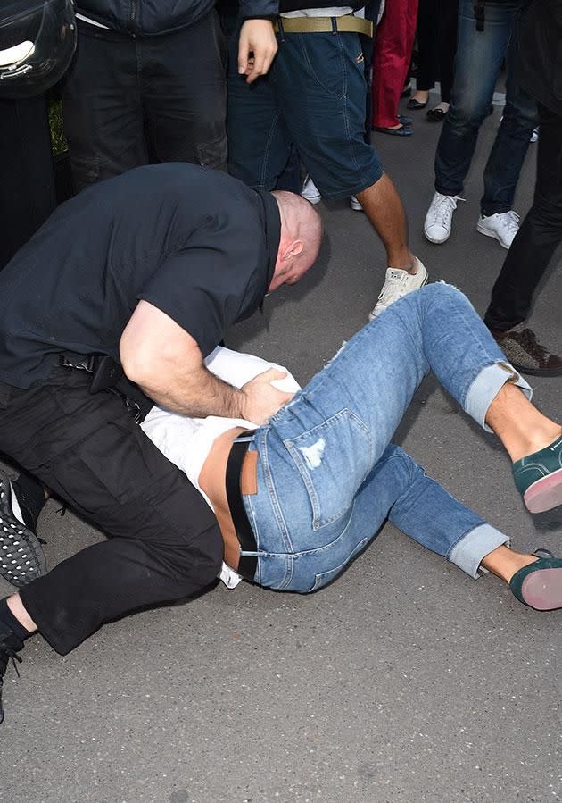 He ended up on the ground surrounded by Kim's security men. Photo: Splash.