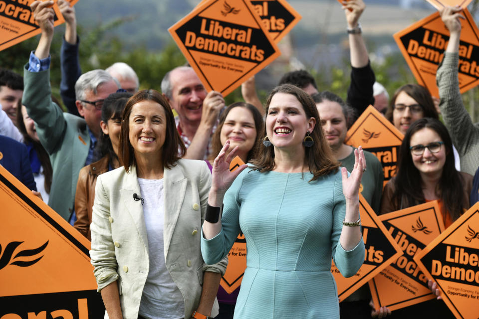Newly-elected Liberal Democrat leader Jo Swinson, right, and Welsh Liberal Democrat leader Jane Dodds celebrate in Brecon, Wales, after the Liberal Democrats win the Brecon and Radnorshire by-election, Friday Aug. 2, 2019. In the Conservatives' first electoral test since Boris Johnson became prime minister nine days ago, the party was defeated for the seat of Brecon and Radnorshire in Wales by Jane Dodds of the opposition Liberal Democrats. (Ben Birchall/PA via AP)