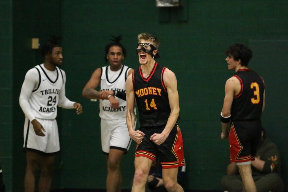 Cardinal Mooney's Dominic Cattivera celebrates after a play during the Cardinals' 59-56 win over Taylor Trillium Academy in a Division 4 state quarterfinal at West Bloomfield High School on Tuesday, March 21, 2023.