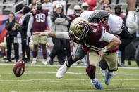 FILE - Michigan Panthers quarterback Shea Patterson (2) fumbles the ball as he is sacked by Houston Gamblers defensive lineman Ahmad Gooden (99) during the first half of a USFL football game Sunday, April 17, 2022, in Birmingham, Ala. A revived United States Football League — borrowing the moniker and team nicknames from a league that went out of business 36 years ago — launched last month with all regular-season games being played in Birmingham. (AP Photo/Butch Dill, File)