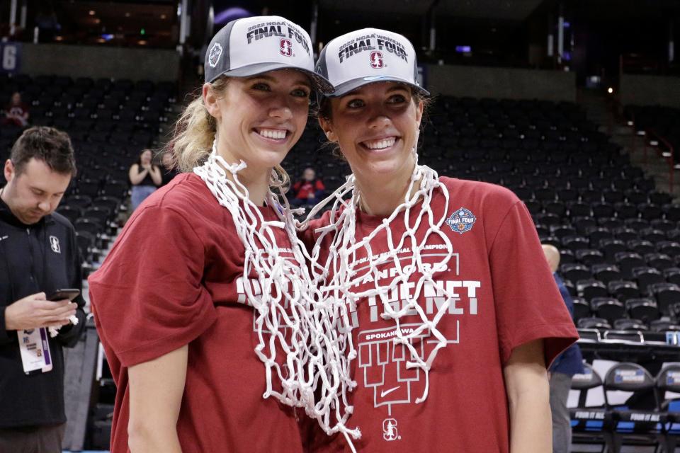 Stanford guards and twin sisters Lexie Hull, left, and Lacie Hull, right, wear nets after they were cut down after a college basketball game against Texas in the Elite 8 round of the NCAA tournament, Sunday, March 27, 2022, in Spokane, Wash. Stanford won 59-50. (AP Photo/Young Kwak)