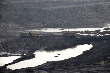 Trucks carrying coal move at Magadh coal mine in Chatra district in the eastern state of Jharkhand, India, September 30, 2015.REUTERS/Stringer