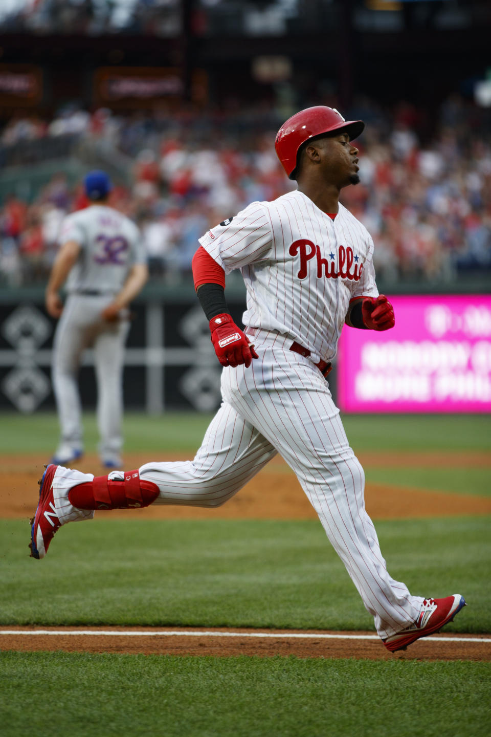 Philadelphia Phillies' Jean Segura, foreground, rounds the bases after hitting a home run off New York Mets starting pitcher Steven Matz, back left, during the first inning of a baseball game, Monday, June 24, 2019, in Philadelphia. (AP Photo/Matt Slocum)