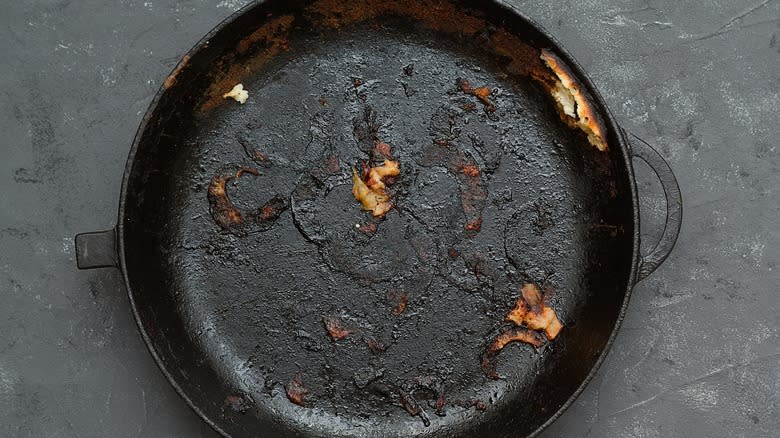 Damaged and dirty cast iron skillet