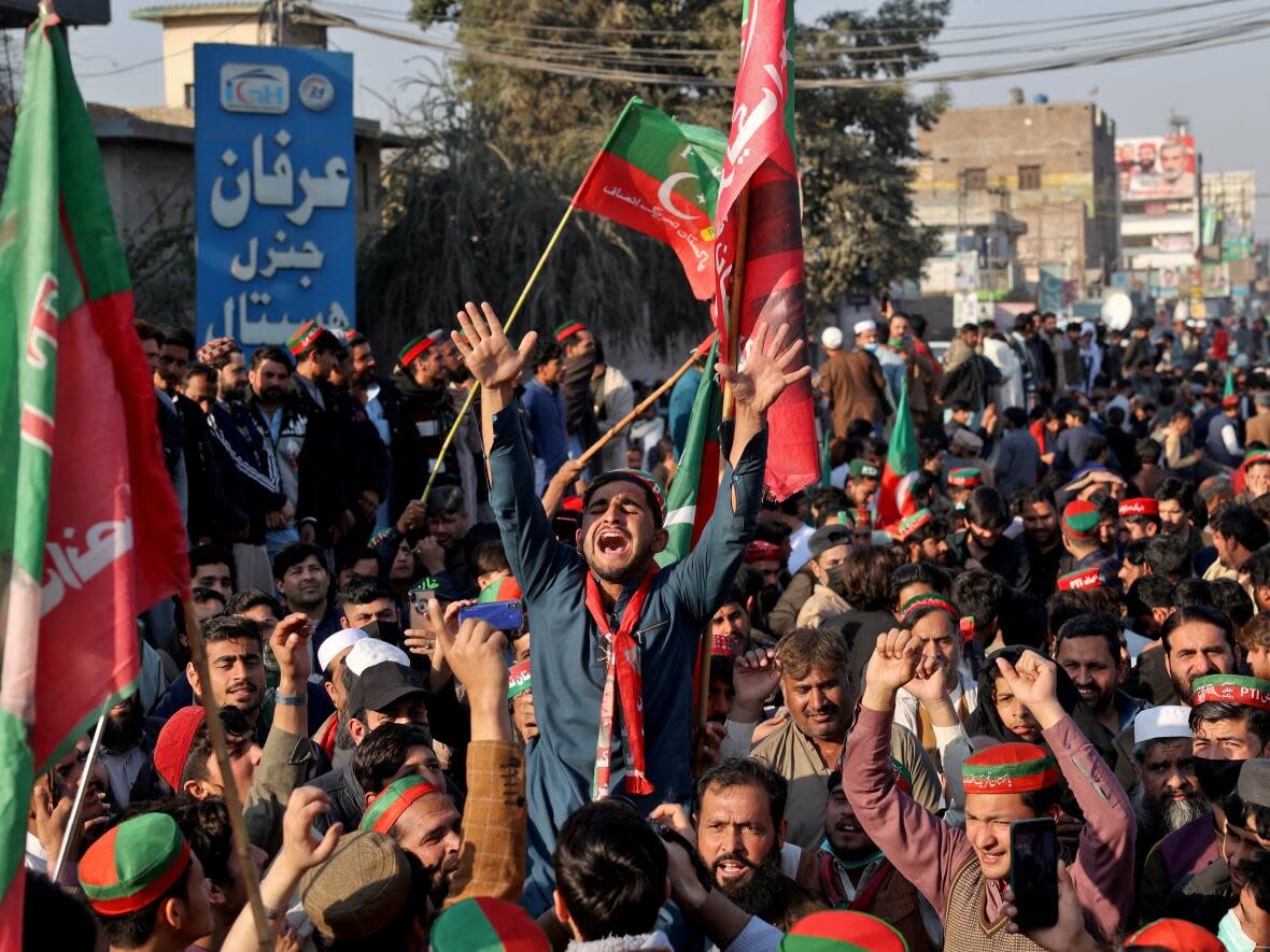 Supporters of former prime minister Imran Khan's party, the Pakistan Tehreek-e-Insaf protest in Peshawar, Pakistan, for free and fair results of the election, after delays in the vote count. (Fayaz Aziz/Reuters - image credit)