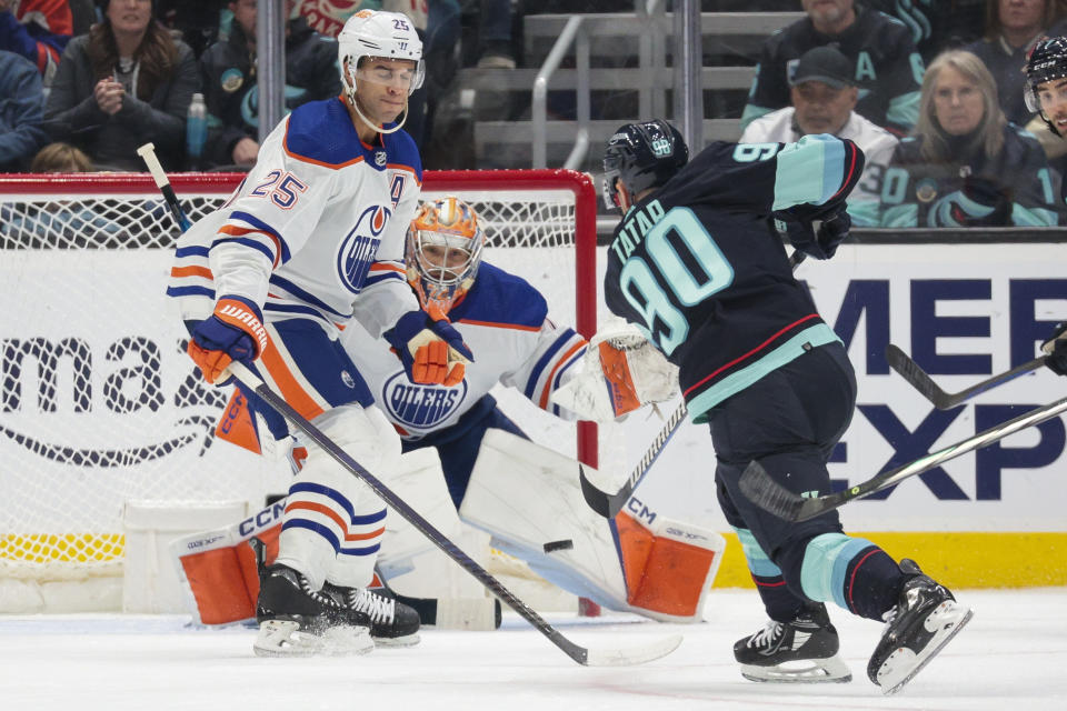 Seattle Kraken left wing Tomas Tatar (90) shots the puck as Edmonton Oilers goaltender Stuart Skinner (74) and defenseman Darnell Nurse (25) defend during the second period of an NHL hockey game Saturday, March 2, 2024, in Seattle. (AP Photo/Jason Redmond)