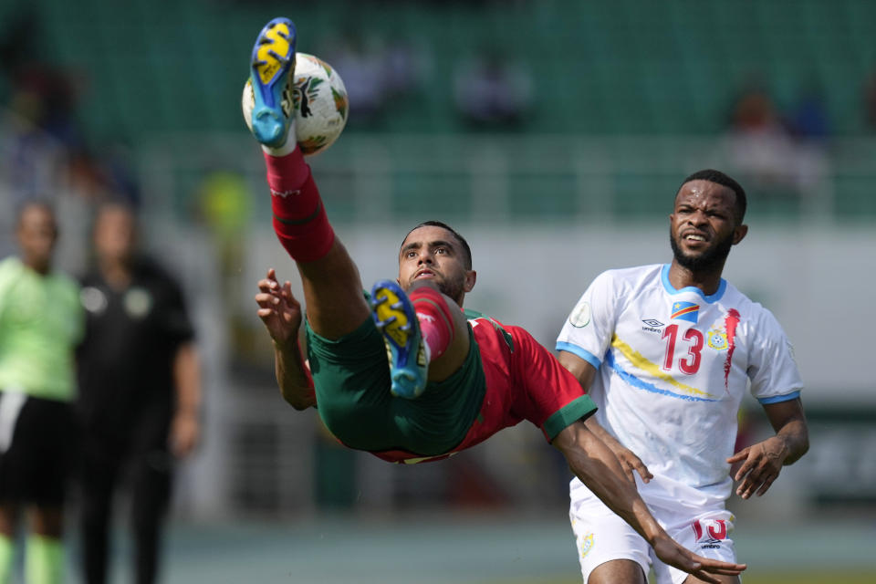 Morocco's Mohamed Chibi, left, jumps for the ball beside DR Congo's Meschack Elia, right, during the African Cup of Nations Group F soccer match between Morocco and DR Congo, at the Laurent Pokou stadium in San Pedro, Ivory Coast, Sunday, Jan. 21, 2024. (AP Photo/Themba Hadebe)
