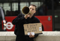 A man holds a banner as he protests in front of 10 Downing Street entrance in central London, Wednesday, March 29, 2017. Britain will begin divorce proceedings from the European Union later on March 29, starting the clock on two years of intense political and economic negotiations that will fundamentally change both the nation and its European neighbors. (AP Photo/Matt Dunham)