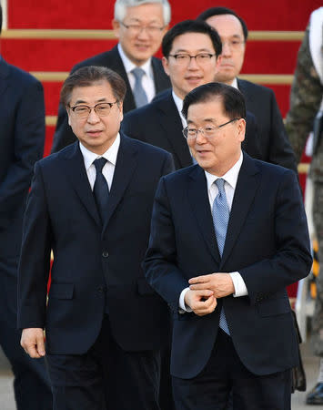 Chung Eui-yong, head of the presidential National Security Office, Suh Hoon, the chief of the South's National Intelligence Service, and other delegates (not pictured) arrive at a military airport in Seongnam, South Korea, March 6, 2018. REUTERS/Song Kyung-Seok/Pool