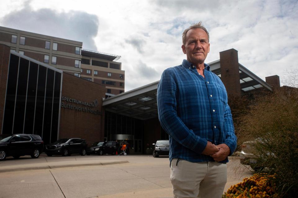 Rob Mackey stands for a portrait Tuesday, Oct. 17, 2023, outside the Spectrum Butterworth Hospital in downtown Grand Rapids. Operations like Mackey's liver transplant were made easier after the merger of Beaumont and Spectrum Health Systems.