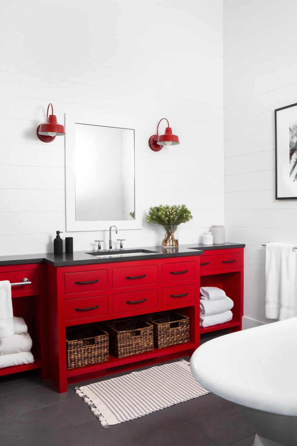 <p> The matching red medicine cabinets and sconce lights make this otherwise all-white bathroom sing. All you need to do is paint a piece of junk shop furniture in a bold shade (it needn't be a red hue – even a more neutral tone can have an eye-catching effect. </p> <p> For a really moody and vampy effect - swap your white walls for something darker like black or navy. </p>