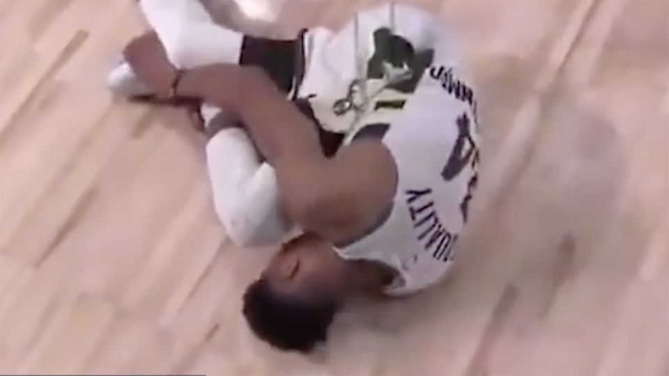 Milwaukee star Giannis Antetokounmpo is pictured lying on the ground and clutching his ankle after injuring it.