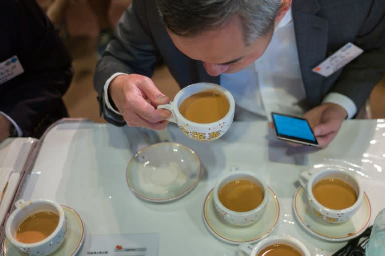 A competition judge takes a sip of milk tea during judging in the Hong Kong Style Milk Tea international final held during the 2016 Hong Kong International Tea Fair on August 13, 2016