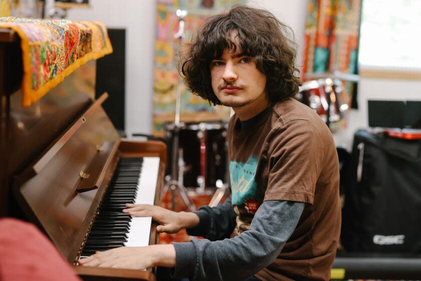 Los Angeles, CA - September 13: Jacob Rock, an autistic 19-year-old, wrote a symphony through a communication app via iPad, and here he poses for a portrait at his home studio on Wednesday, Sept. 13, 2023 in Los Angeles, CA. His symphony will be staged on September 30th at the Alex Theatre in Glendale. (Dania Maxwell / Los Angeles Times)