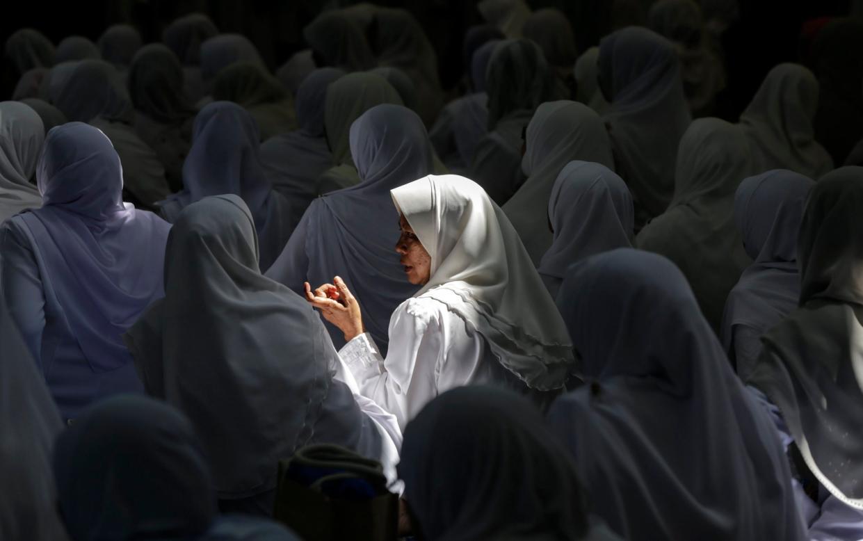 Malaysian Muslim women chats during Koran reciting programme at a mosque during the holy fasting month of Ramadan in Kuala Lumpur, Malaysia - AHMAD YUSNI/EPA