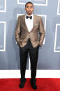 <b>Nas</b><br> <b>Grade: A</b><br> The rapper was nominated for four statues at this year's Grammys, but we'd say he's a winner just for showing up in this dapper gold, black, and white getup punctuated with a bow tie.