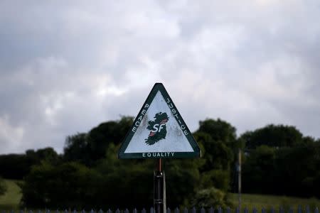 A road sign is seen with a Sinn Fein message of peace, justice and equality pasted on it in Armagh, Northern Ireland June 28, 2016. REUTERS/Clodagh Kilcoyne
