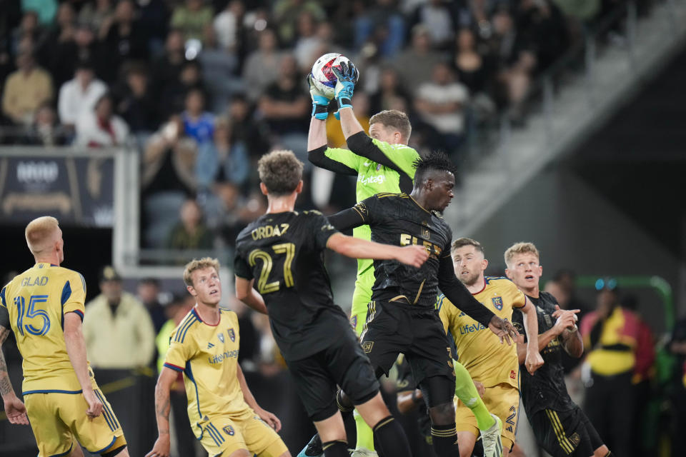 Real Salt Lake goalkeeper Zac MacMath, top, makes a save during the second half of an MLS soccer match against Los Angeles FC Sunday, Oct. 1, 2023, in Los Angeles. (AP Photo/Jae C. Hong)