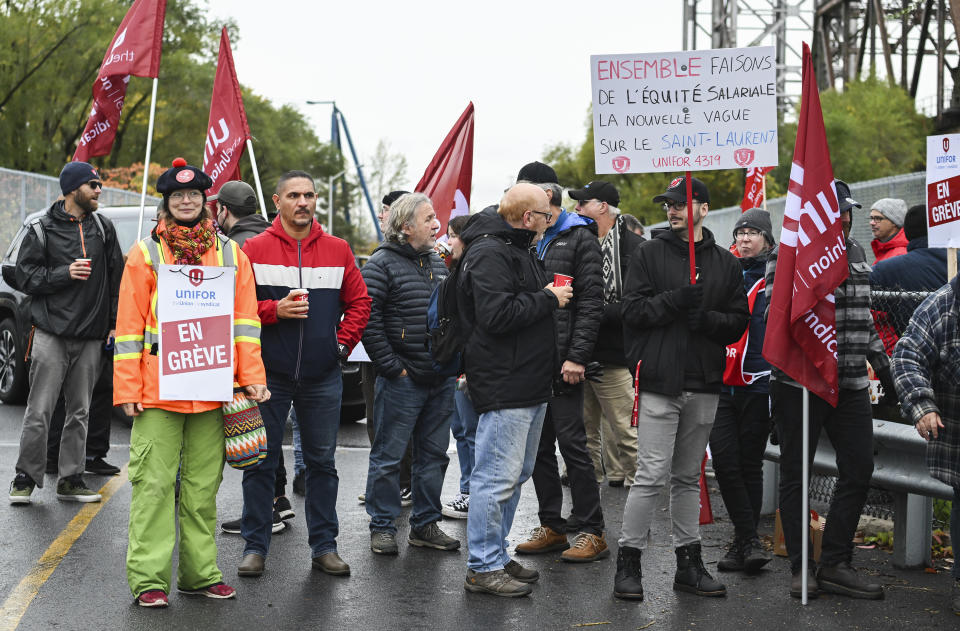 Striking St. Lawrence Seaway workers picket outside the St. Lambert Lock in St. Lambert, Quebec, Monday, Oct. 23, 2023. A strike has shut down all shipping on the St. Lawrence Seaway, interrupting exports of grain and other goods from Canada and the United States via the Great Lakes to the world.(Graham Hughes/The Canadian Press via AP)