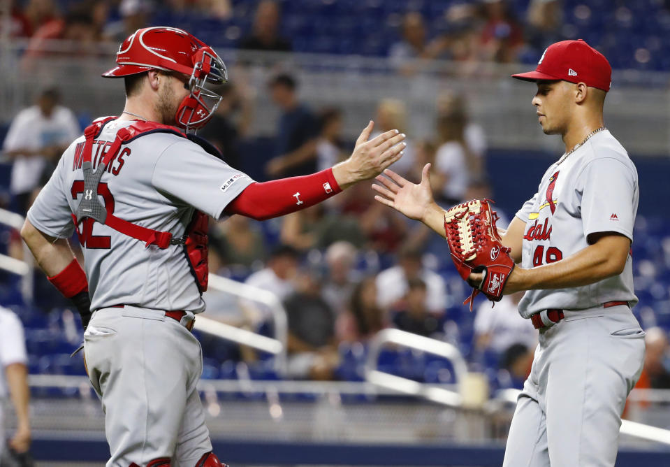 St. Louis Cardinals relief pitcher Jordan Hicks, right, and catcher Matt Wieters congratulate each other after they defeated the Miami Marlins in a baseball game, Monday, June 10, 2019, in Miami. (AP Photo/Wilfredo Lee)